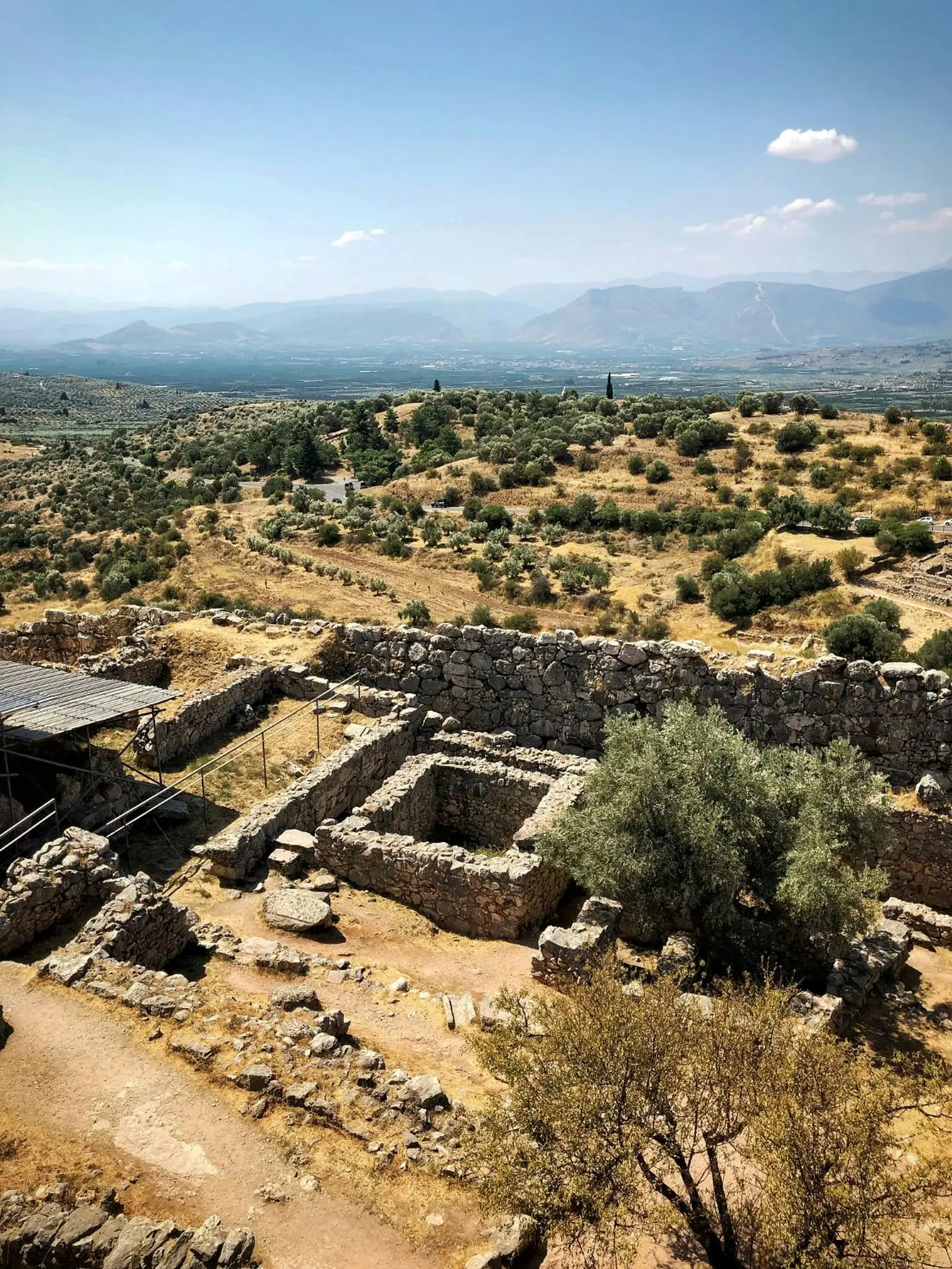 Stone walls and foundations of the citadel of Mycenae, with the plain below